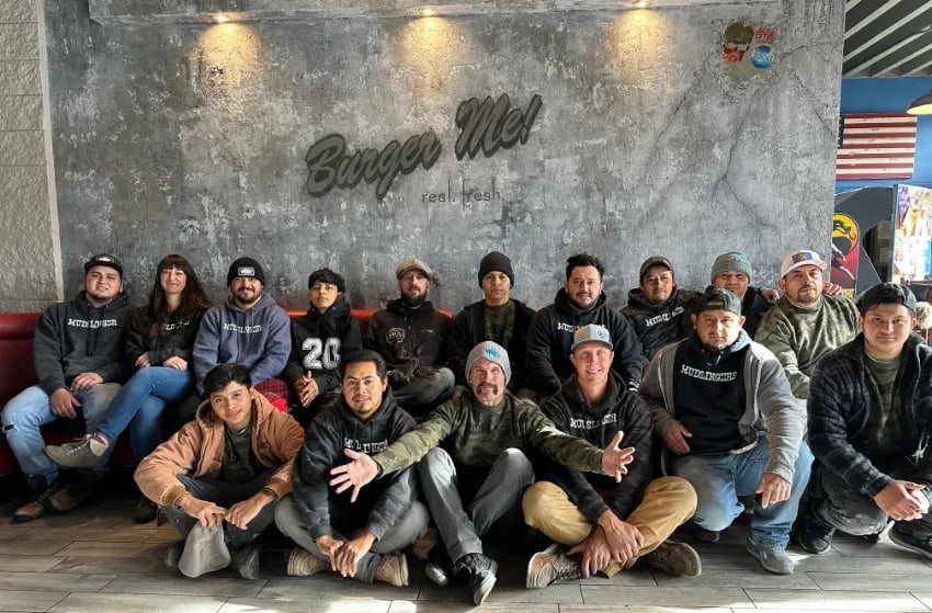 The Rebel Venetian and Mudslingers crew at Burger Me in Truckee, in front of a plaster wall they finished