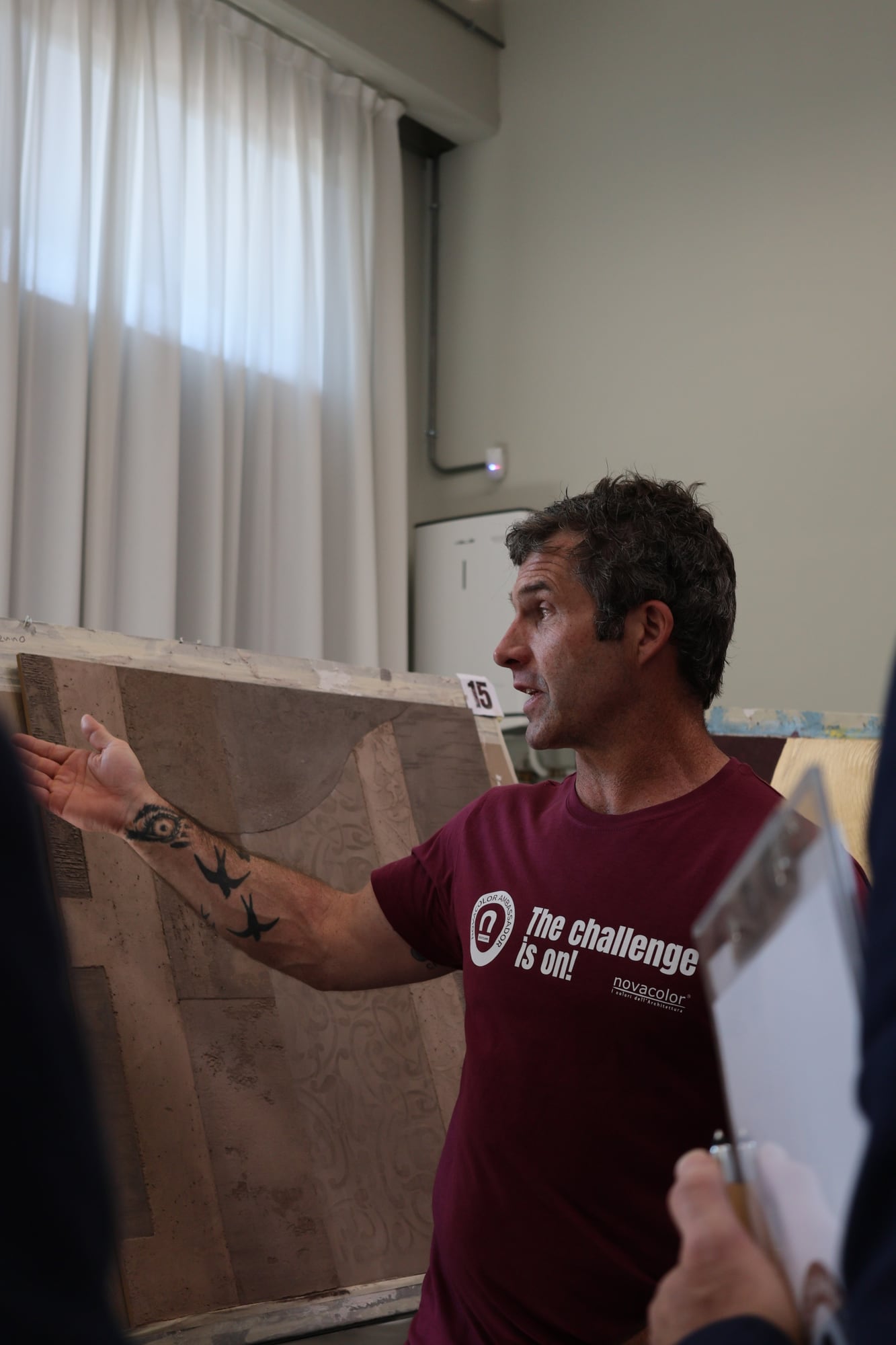 Kyle Railton explaining his plaster panel at the Novacolor Ambassador Bootcamp in Venice